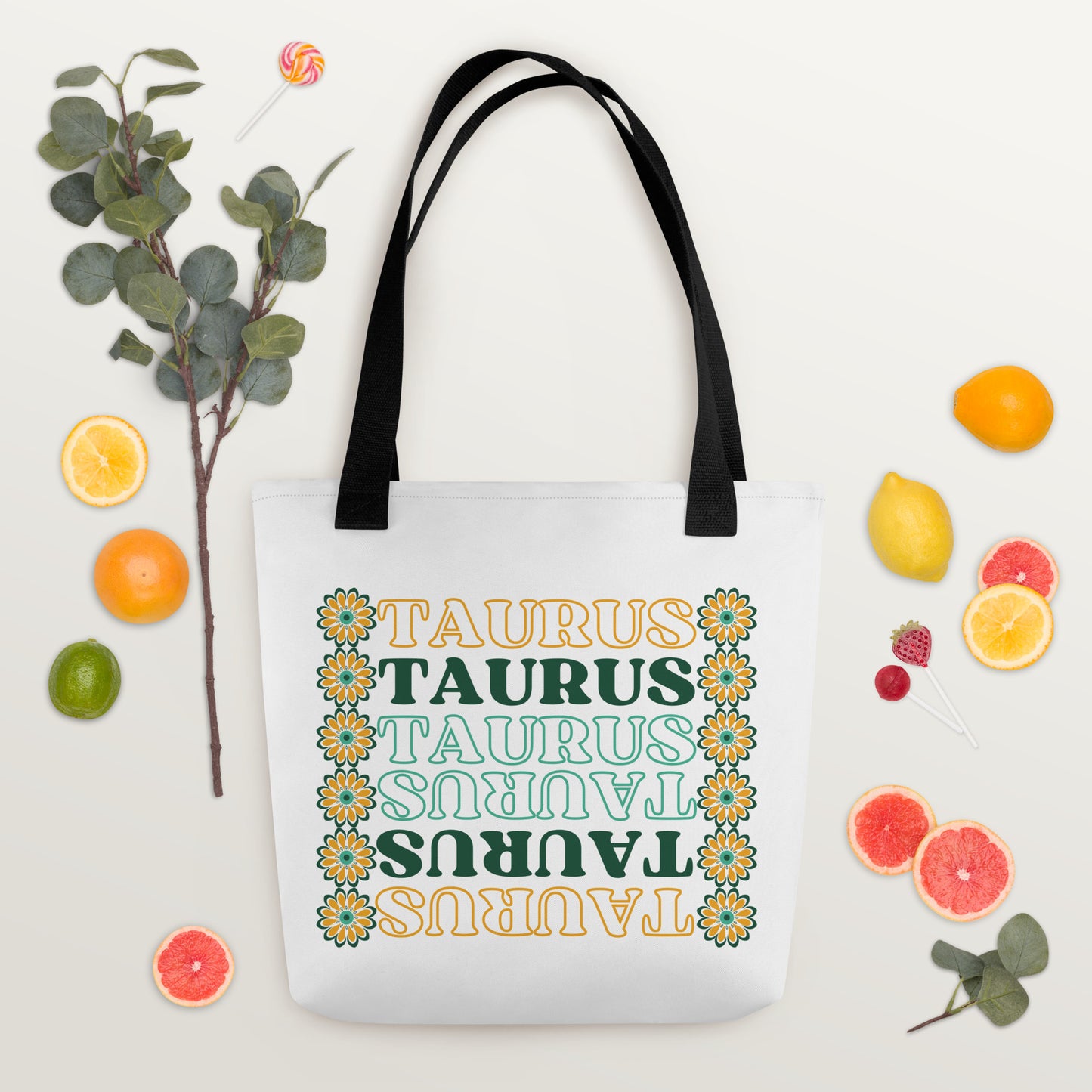 colorful retro Taurus tote bag with black bag straps, green and yellow flowers, and green and yellow text