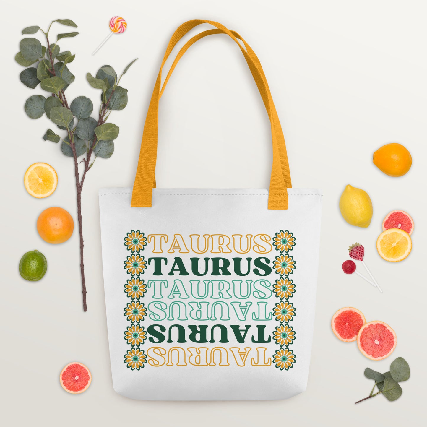 colorful retro Taurus tote bag with yellow bag straps, green and yellow flowers, and green and yellow text