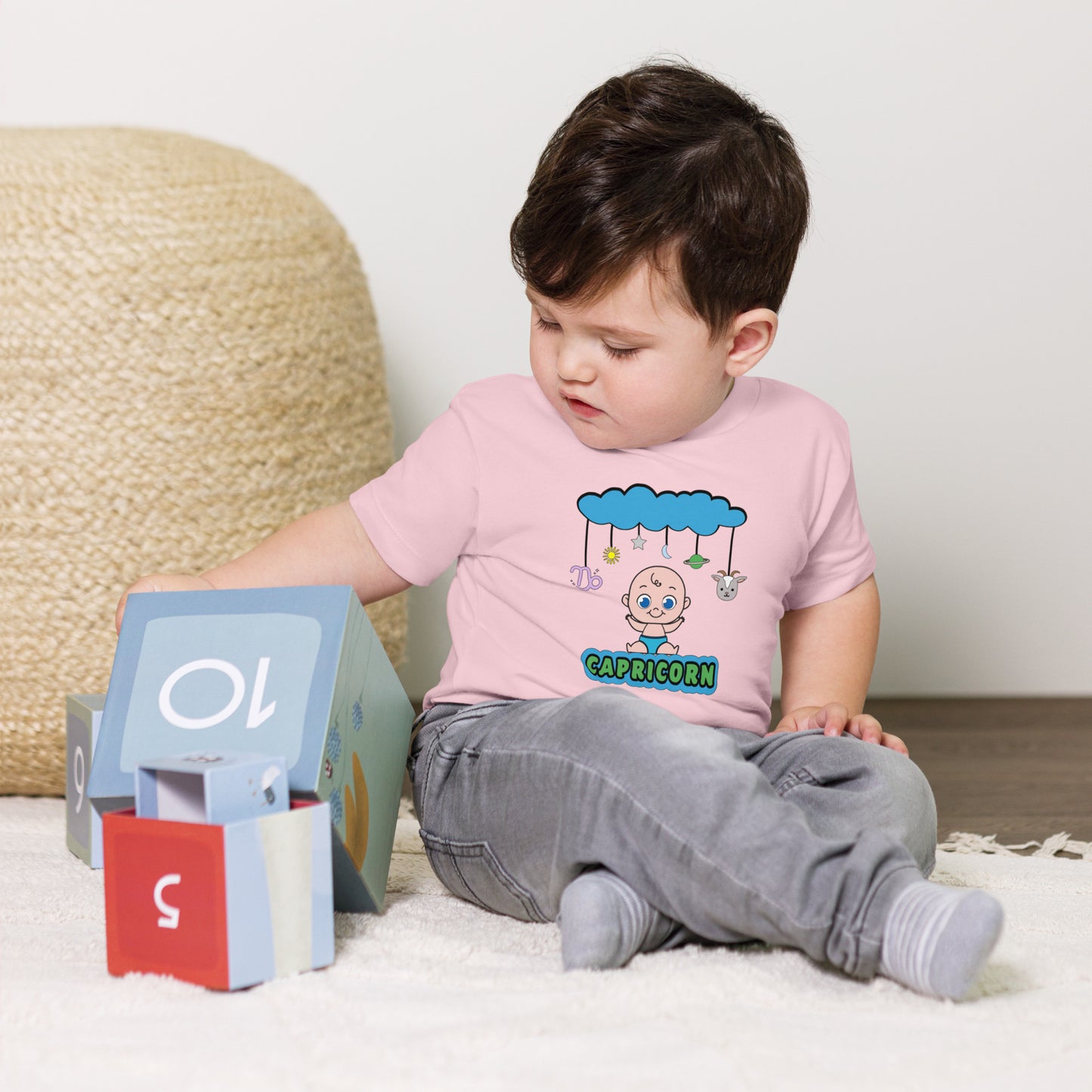 pink Baby T-shirt with Capricorn symbol and celestial design