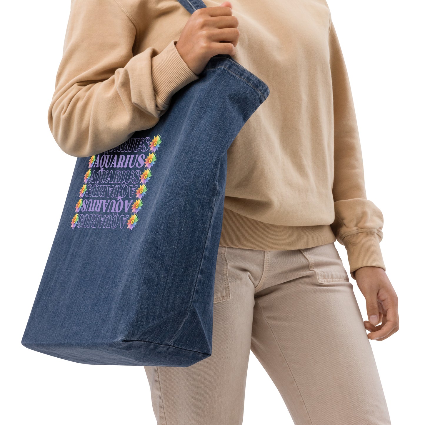 Denim tote bag featuring colorful flowers with the word ‘Aquarius’ repeated in a vertical row in purple text. The design combines floral elegance with a touch of celestial charm