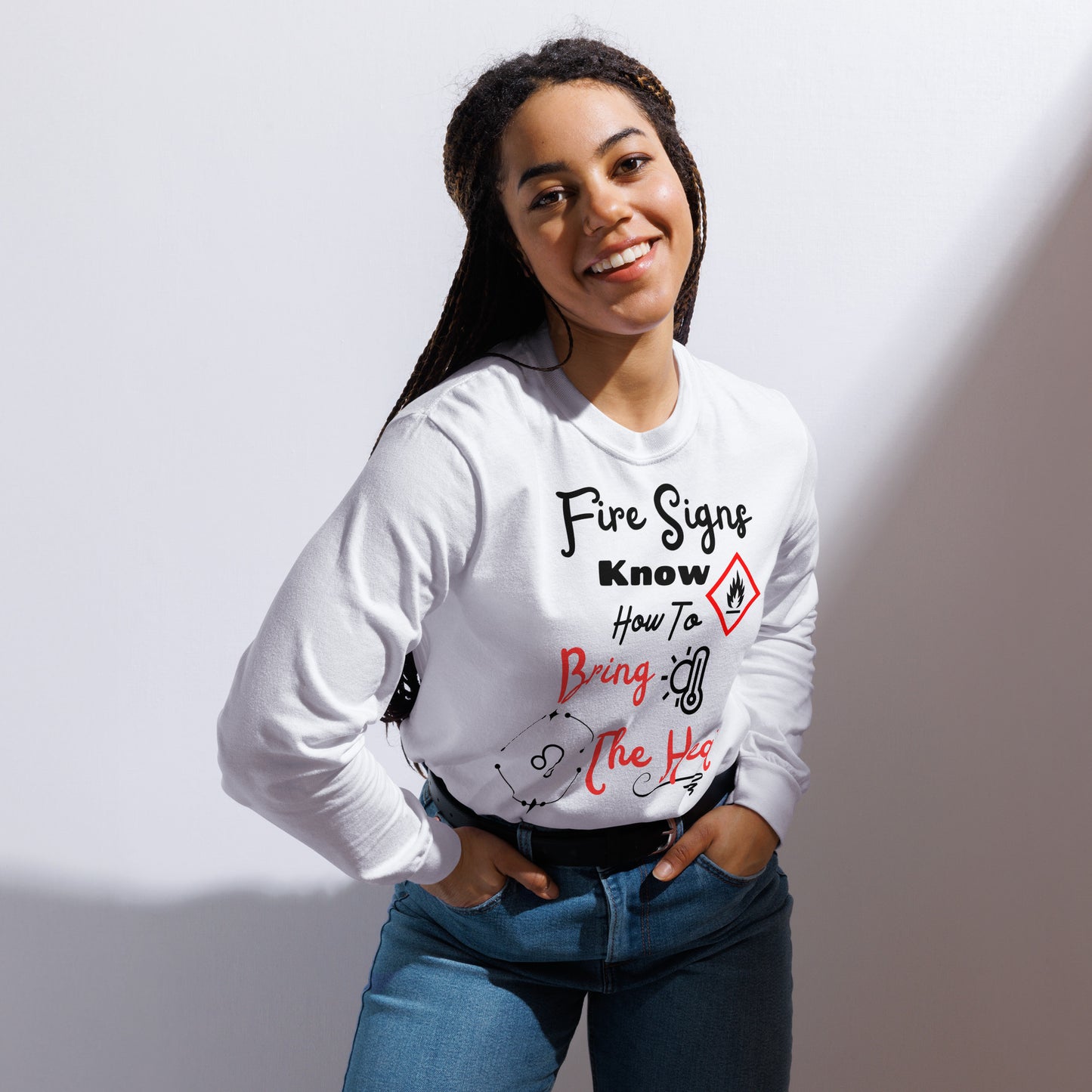 A woman wearing A vibrant long sleeve tee with the text "Fire Signs Bring the Heat," designed for Leos. The shirt features bold flames and dynamic lettering, perfect for showcasing Leo's energetic and charismatic spirit.