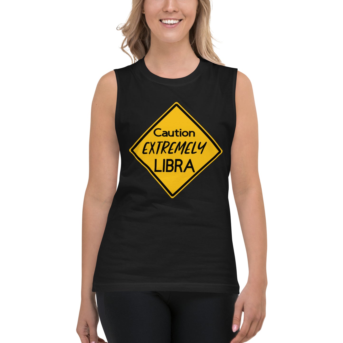 A person wearing a tank top with a yellow sign that reads "Caution: Extremely Libra."