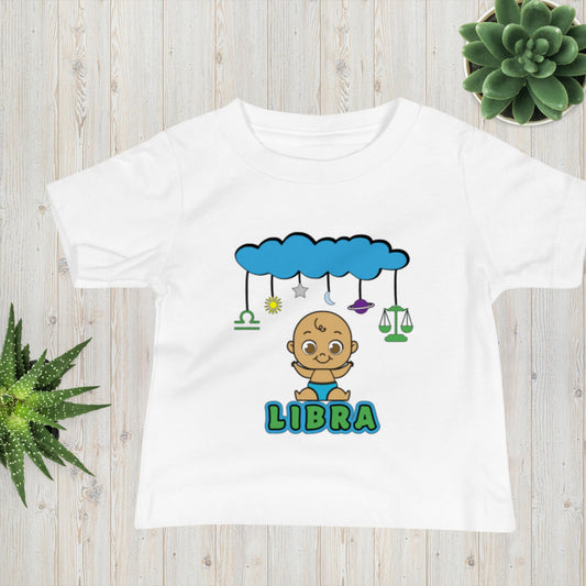 white toddler t-shirt with cute brown baby smiling underneath cloud mobile design and libra astrology symbols