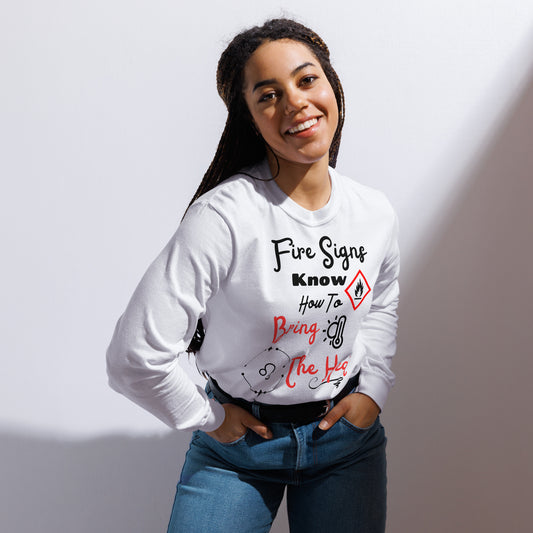 A woman wearing A vibrant long sleeve tee with the text "Fire Signs Bring the Heat," designed for Leos. The shirt features bold flames and dynamic lettering, perfect for showcasing Leo's energetic and charismatic spirit.
